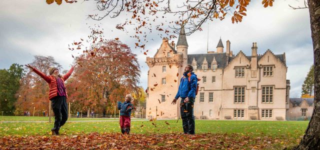 Family playing Autumn leaves at Brodie Castle