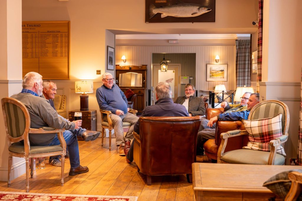 A group holiday relaxing in the lounge at top Scottish Hotel, the Ulbster Arms Hotel.